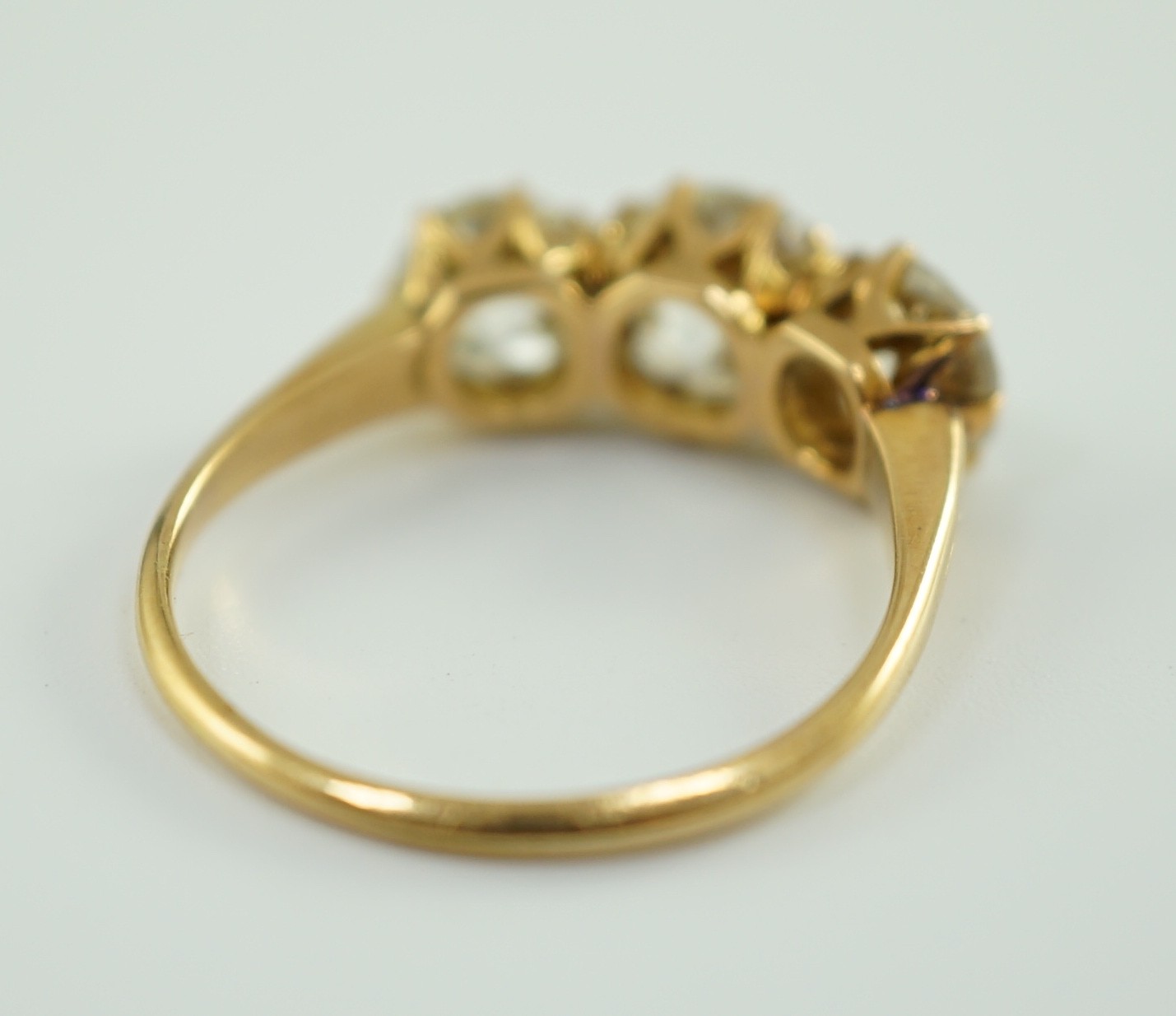 A gold and three stone diamond ring